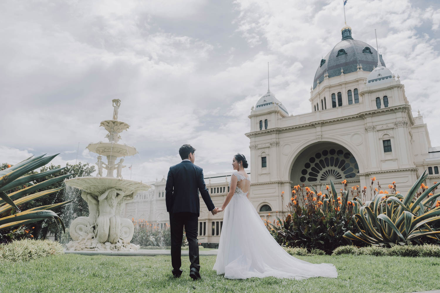 Pre-Wedding Photography shot in carlton Garden. Couple  stand in front of the fountain looking at each other.